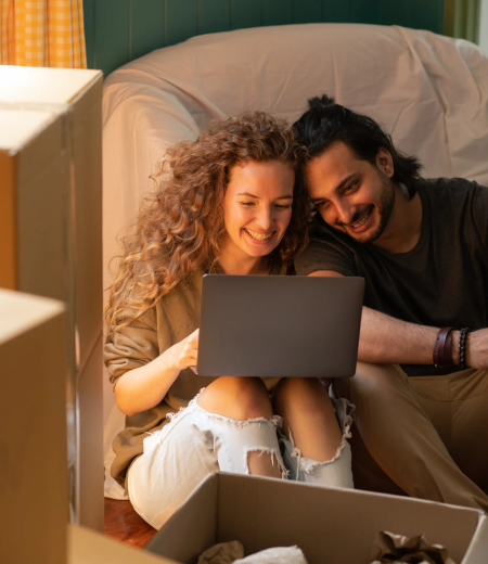 Couple smiling at a laptop